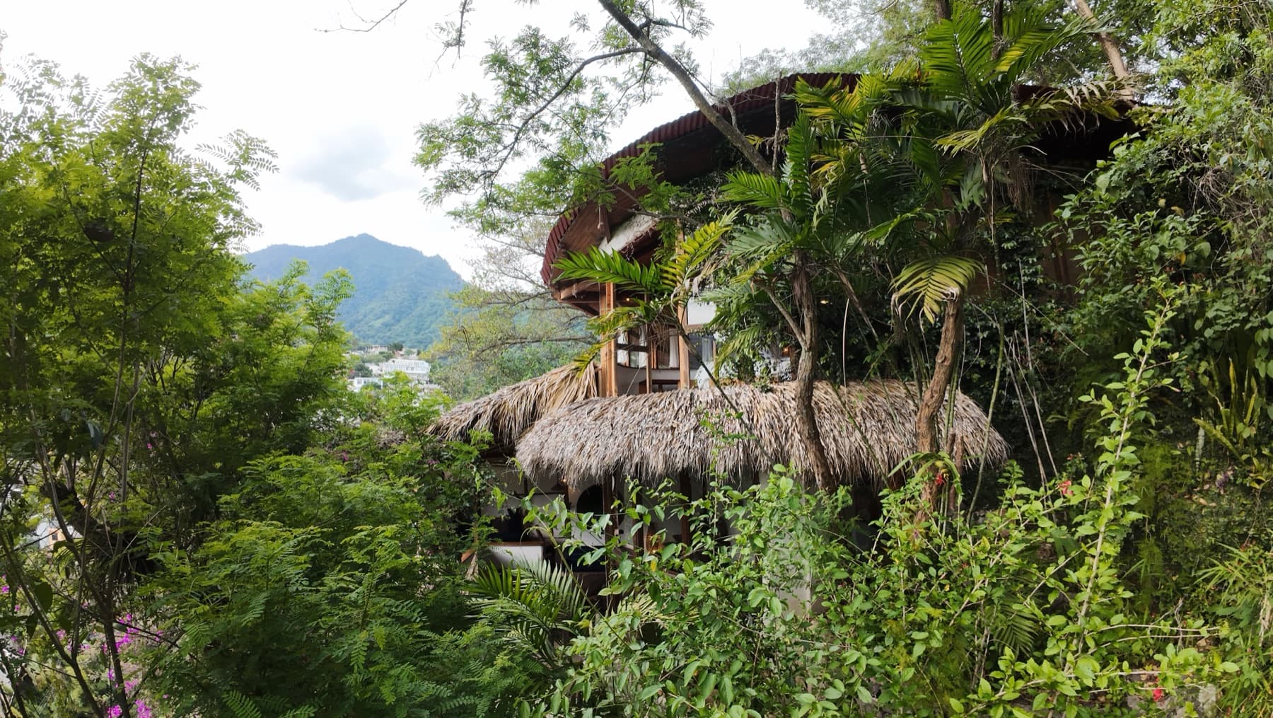 Stone casita with bougainvillea above the lake